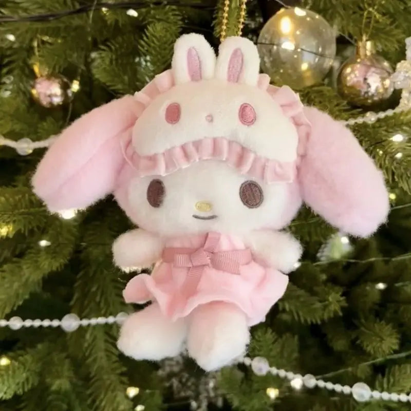Pink Melody  plush toy hanging on a decorated Christmas tree.